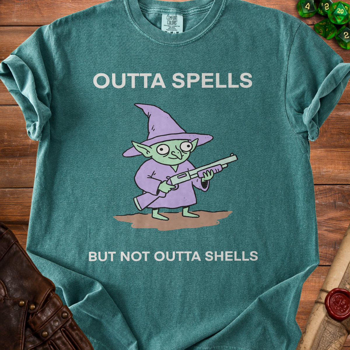 Teal t-shirt with a goblin holding a rifle, saying "OUTTA SPELLS BUT NOT OUTTA SHELLS".