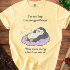 Yellow t-shirt with a penguin sleeping on a cloud and text: "I'm not lazy, I'm energy-efficient. Why waste energy when I can save it?"
