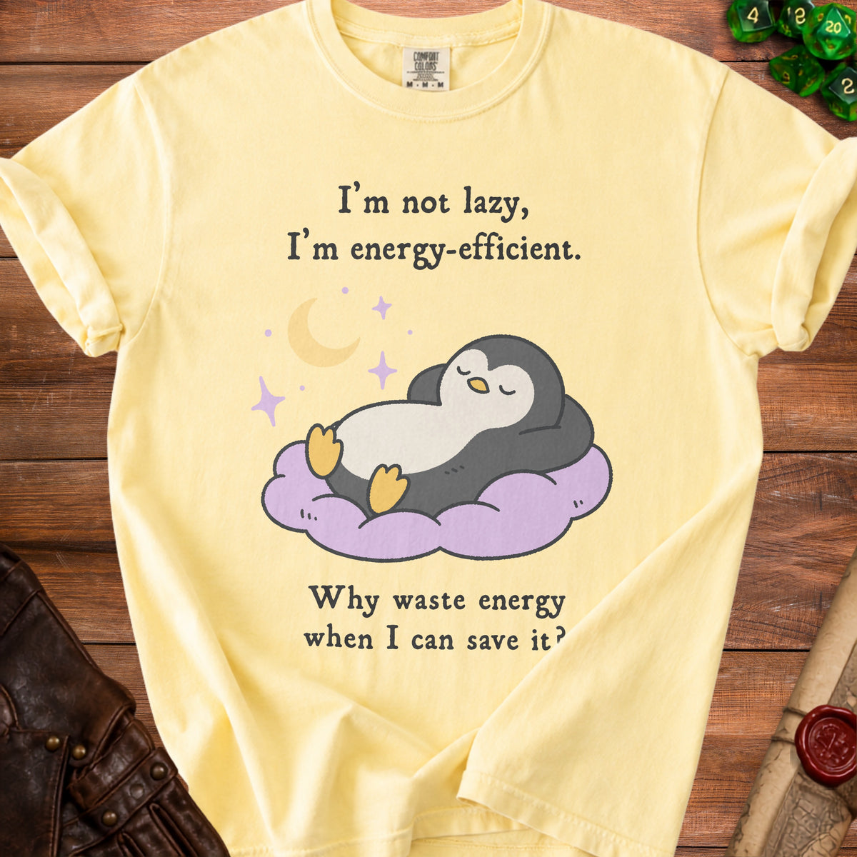 Yellow t-shirt with a penguin sleeping on a cloud and text: "I'm not lazy, I'm energy-efficient. Why waste energy when I can save it?"