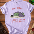 Lavender t-shirt with a green dragon under a blanket and text "Not Today. I need to recharge my social battery."