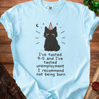 Light blue t-shirt with a graphic of a black cat wearing a party hat and the text "I've tasted 9-5 and I've tasted unemployment I recommend not being born."