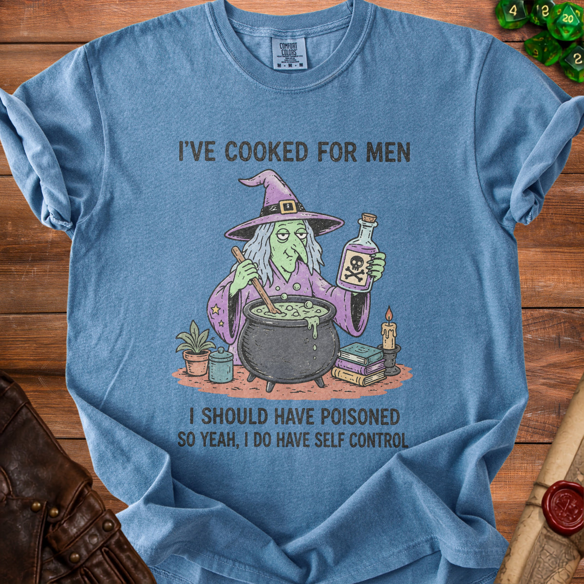 Blue t-shirt with cartoon witch stirring cauldron, holding poison bottle. Text says "I'VE COOKED FOR MEN" and "I SHOULD HAVE POISONED SO YEAH, I DO HAVE SELF CONTROL".