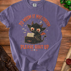 Purple t-shirt with a graphic of a devil typing "To Whom It May Concern Please Shut Up."