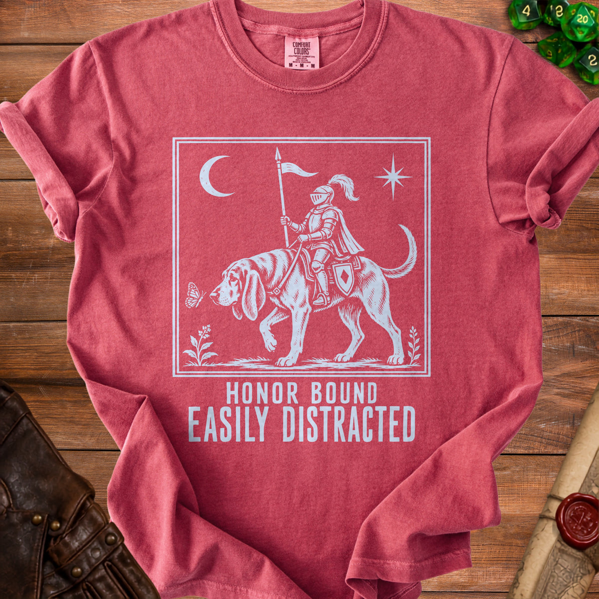 Red t-shirt with knight on dog graphic, text "HONOR BOUND EASILY DISTRACTED".