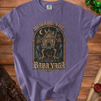 T-shirt graphic with "Beware the Baba Yaga" text, featuring a scary hut on chicken legs.