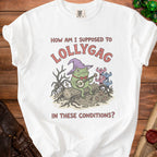 White t-shirt graphic with a frog playing banjo and text "How am I supposed to lollygag in these conditions?".