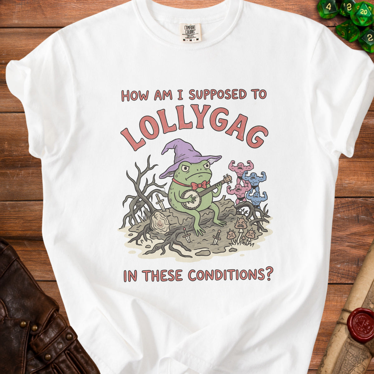 White t-shirt graphic with a frog playing banjo and text "How am I supposed to lollygag in these conditions?".