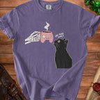 Skeleton hand offers a game controller mug of coffee to a black cat that reads "one more game?".