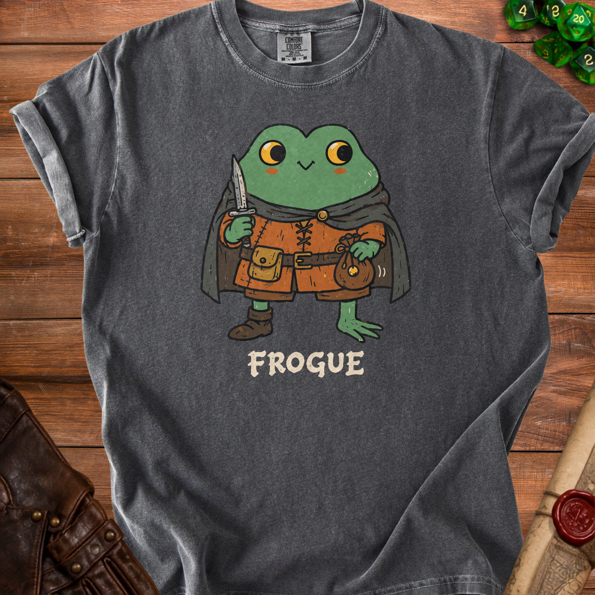 Dark grey t-shirt with a frog character dressed as a rogue holding a knife and bag.