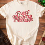 Cream t-shirt with red text reading "Easily Distracted By Side Quests."