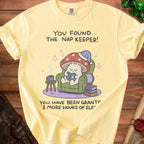 Yellow t-shirt with a mushroom character reading and the text "You found the nap keeper! You have been granted 3 more hours of sleep."