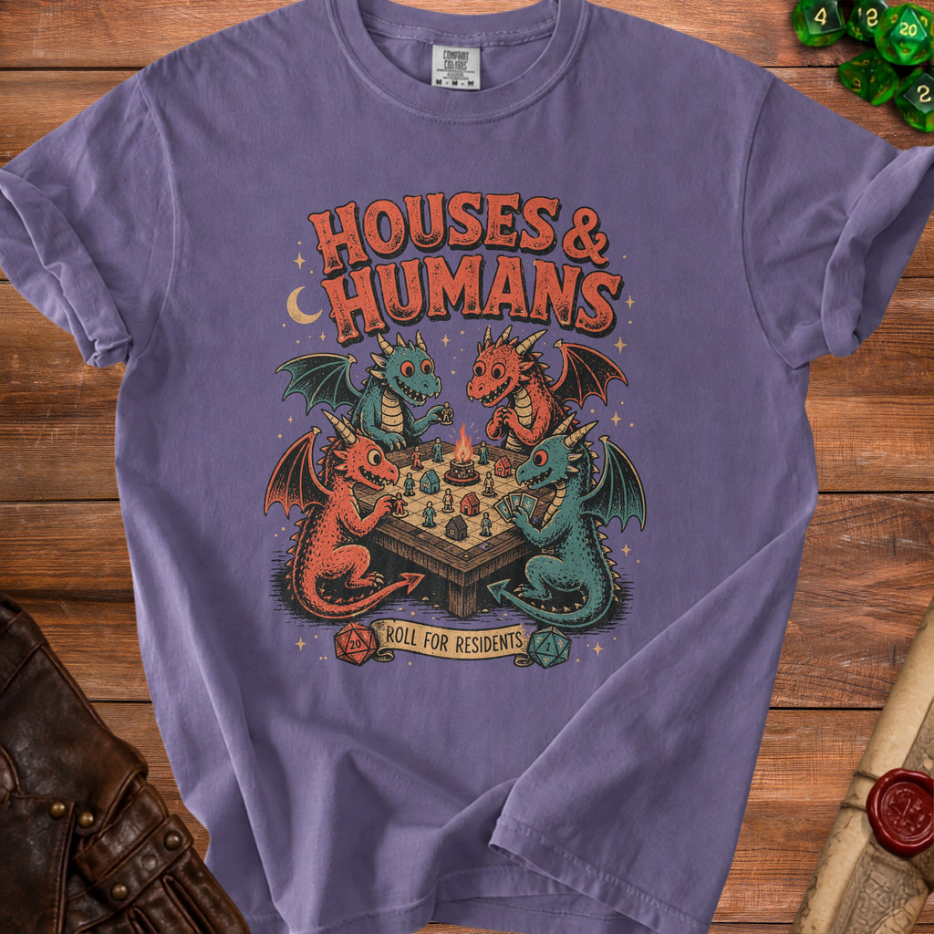 Purple t-shirt with a graphic of dragons playing a board game with dice and text "HOUSES & HUMANS" and "ROLL FOR RESIDENTS".