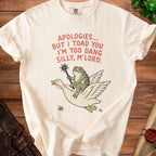 Cream t-shirt with frog riding goose graphic and text "Apologies... but I toad you I'm too dang silly, M'lord."