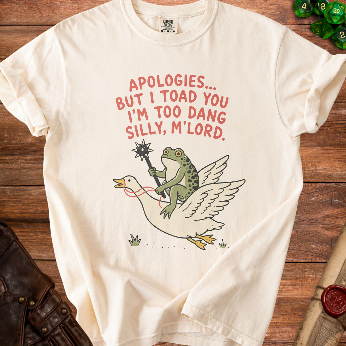 Cream t-shirt with frog riding goose graphic and text "Apologies... but I toad you I'm too dang silly, M'lord."