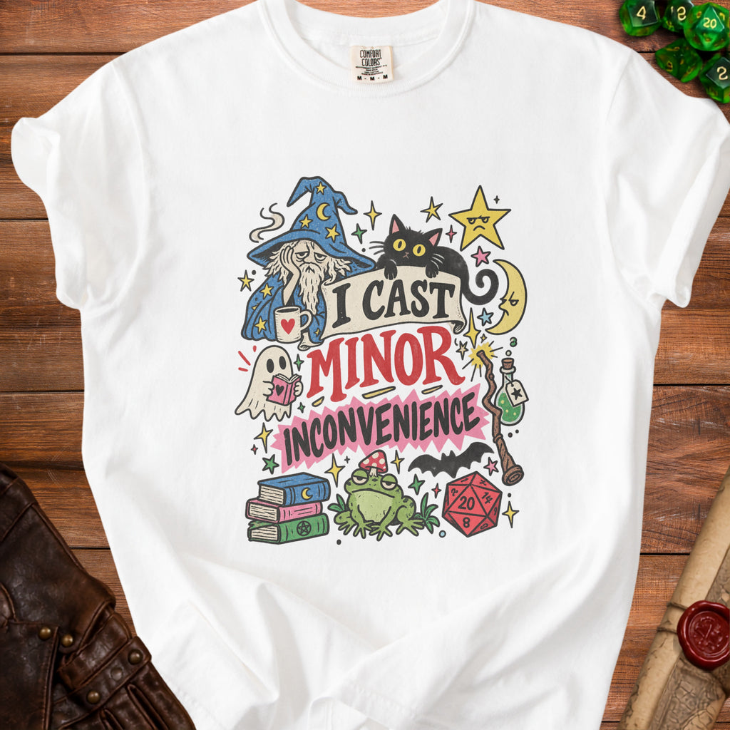 White t-shirt with "I Cast Minor Inconvenience" graphic featuring a wizard, cat, and dice.