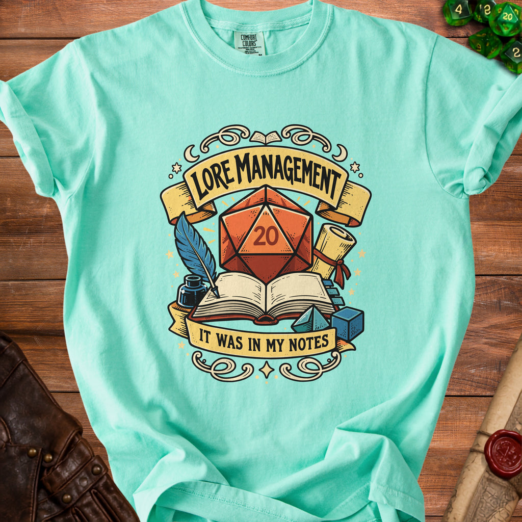 Aqua t-shirt with "Lore Management It Was In My Notes" text and D20 graphic.