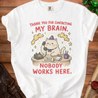 White t-shirt with graphic of cat answering phone: "Thank You For Contacting My Brain. Nobody Works Here."