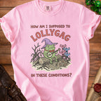 Pink t-shirt with a frog playing a banjo under a wizard hat and text "How am I supposed to lollygag in these conditions?"