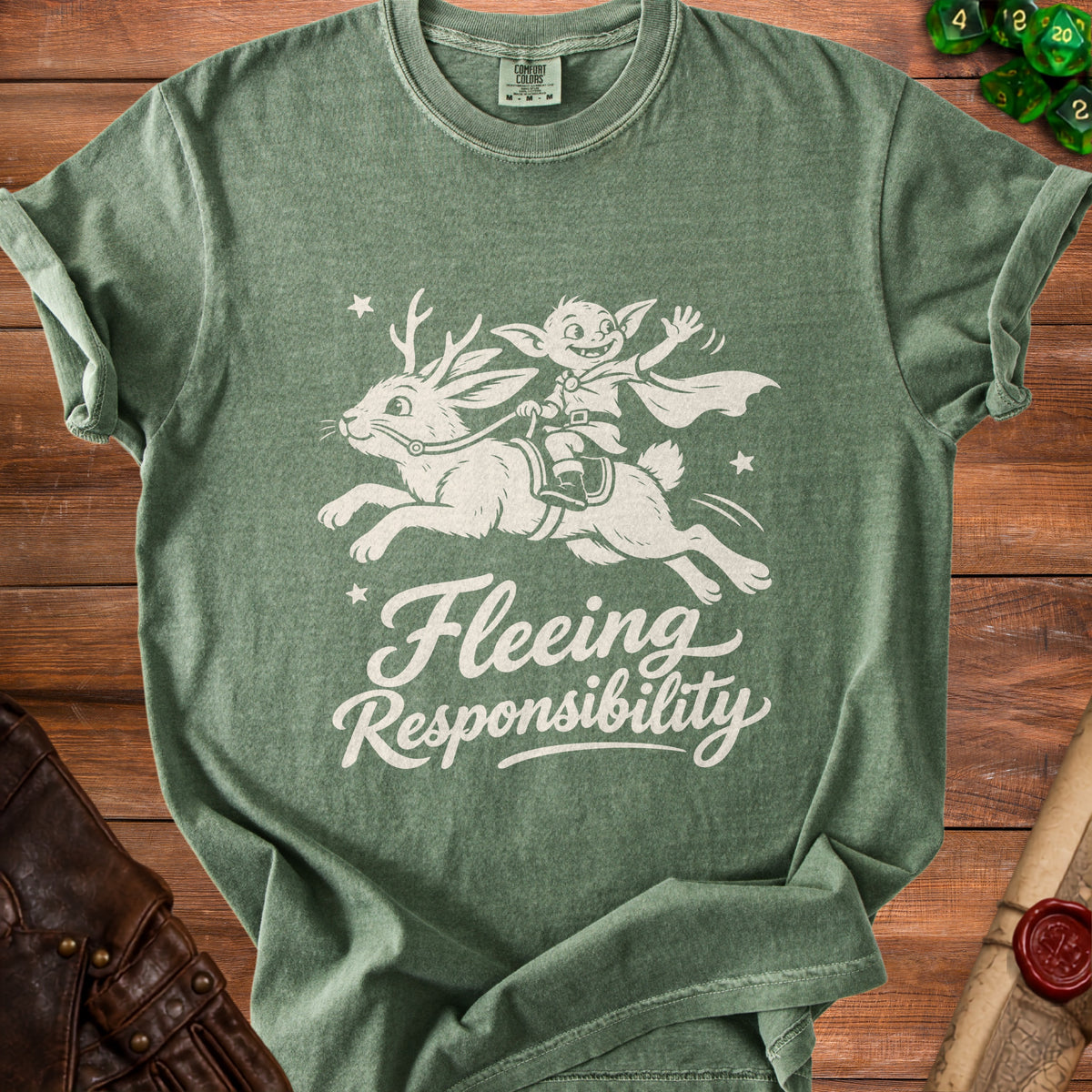Green t-shirt with white graphic of goblin riding a rabbit and text "Fleeing Responsibility".