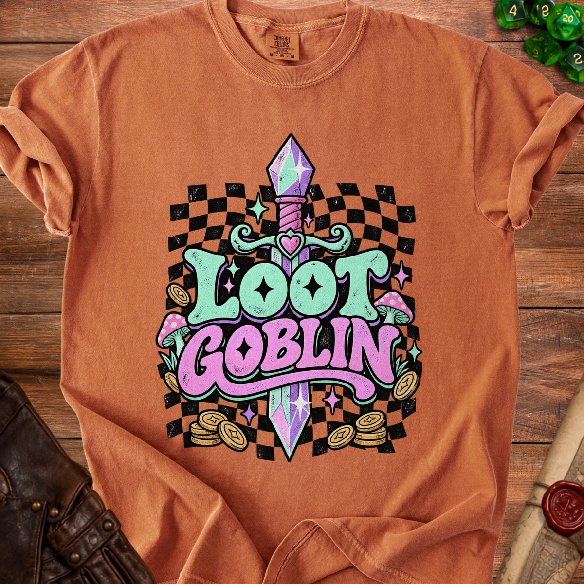 Orange t-shirt with "Loot Goblin" text, a sword, mushrooms, coins, and dice.