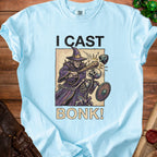 Light blue t-shirt with "I CAST BONK!" graphic of a wizard attacking a skeleton.