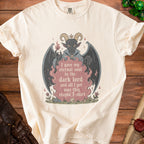 Cream t-shirt with a gothic demon graphic and text reading "I gave my eternal soul to the dark lord and all I got was this stupid T-shirt".