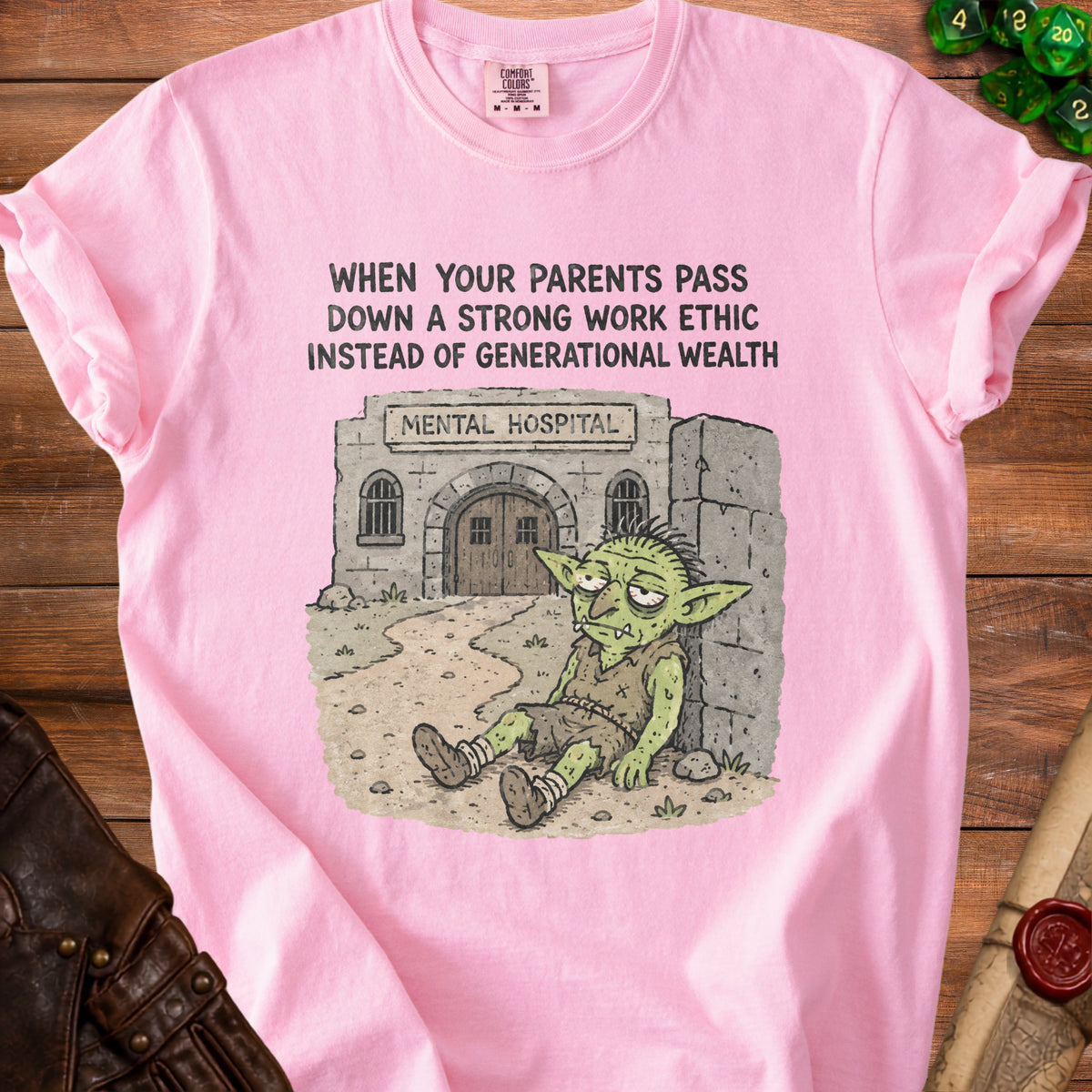 Pink t-shirt with text and illustration of a tired goblin outside a mental hospital.