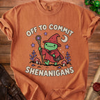 Orange t-shirt with frog wizard graphic saying "Off to commit shenanigans".