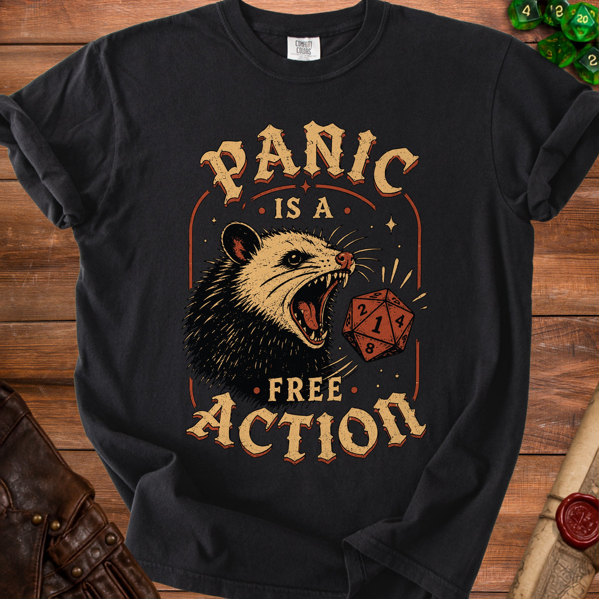Black t-shirt graphic with screaming possum and dice, reading "Panic is a free action".