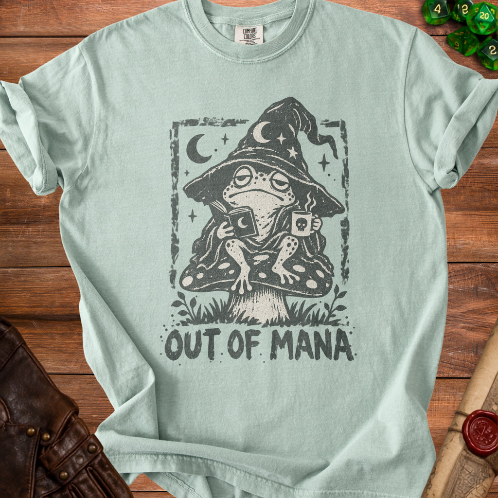 Pale green t-shirt with frog wizard reading and drinking coffee, saying "Out of Mana".