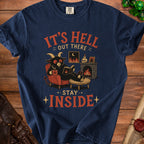 Dark blue t-shirt graphic with text "IT'S HELL OUT THERE STAY INSIDE" and a demon reading.