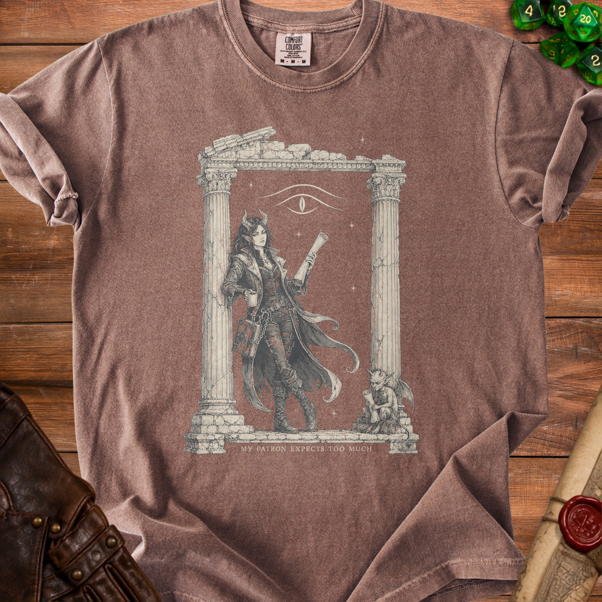 Brown t-shirt with demonic woman, scroll, gargoyle, and text "MY PATRON EXPECTS TOO MUCH".