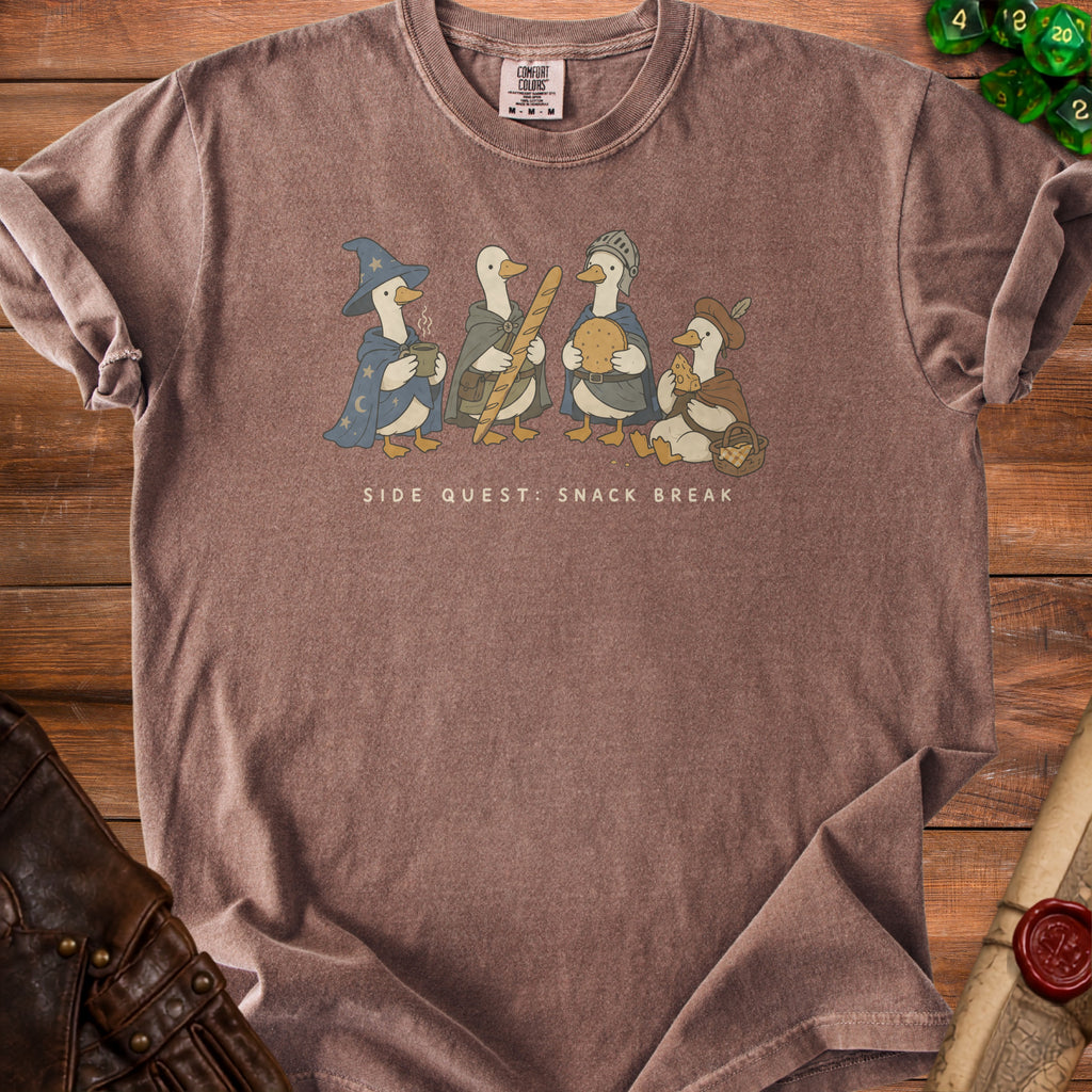 T-shirt with cartoon ducks dressed as fantasy characters on a wooden background.