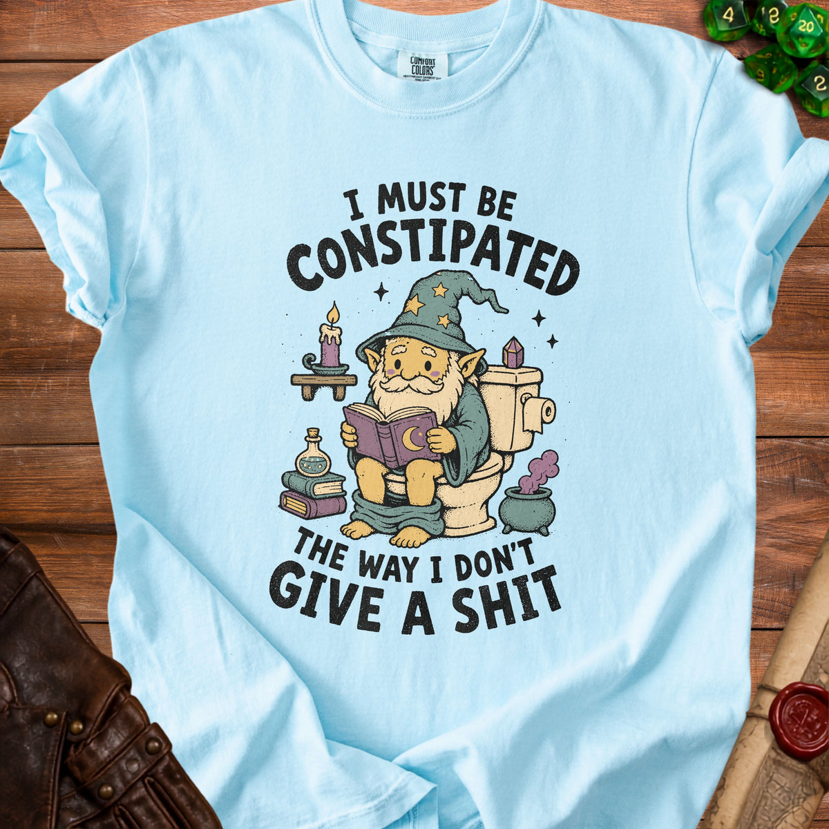 Light blue t-shirt with wizard on toilet reading, "I must be Constipated. The Way I Don't Give a Shit."