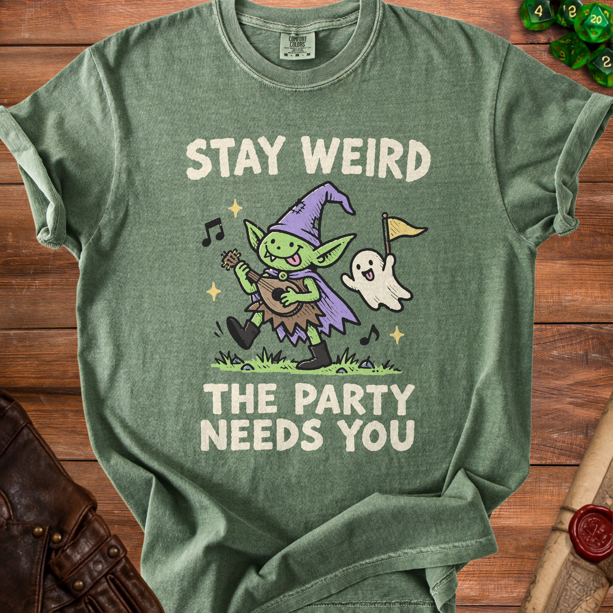 Green t-shirt with a goblin playing music and a ghost with text "STAY WEIRD THE PARTY NEEDS YOU".
