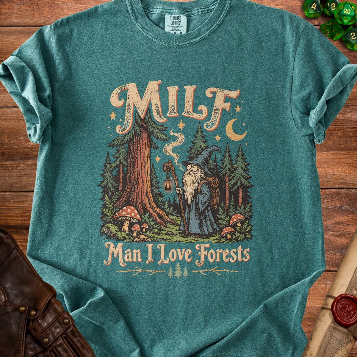 Teal t-shirt with a graphic of a wizard in a forest reading "MILF Man I Love Forests."