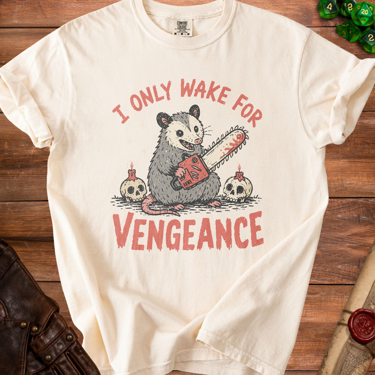 Cream t-shirt with opossum holding chainsaw, skulls, and text "I ONLY WAKE FOR VENGEANCE".