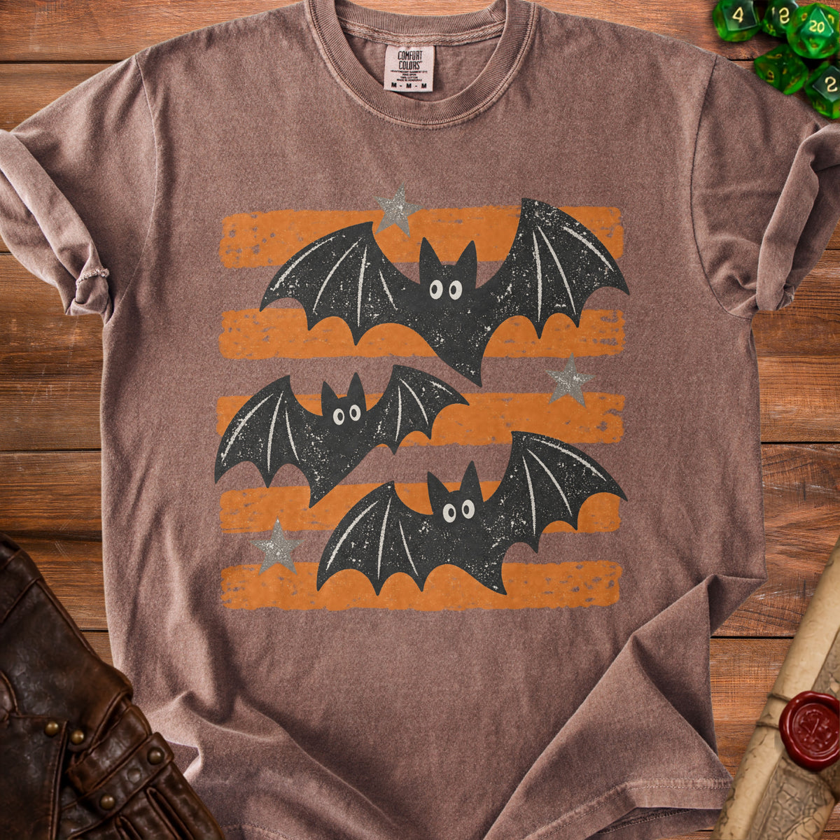 Brown t-shirt with distressed graphic of three bats and orange stripes.