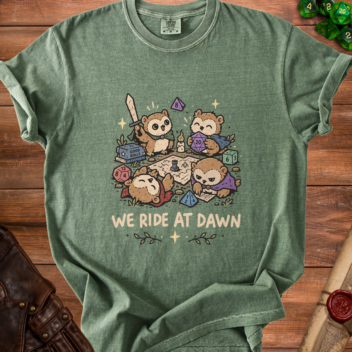 T-shirt with cartoon owls playing a tabletop role-playing game and the text "WE RIDE AT DAWN."