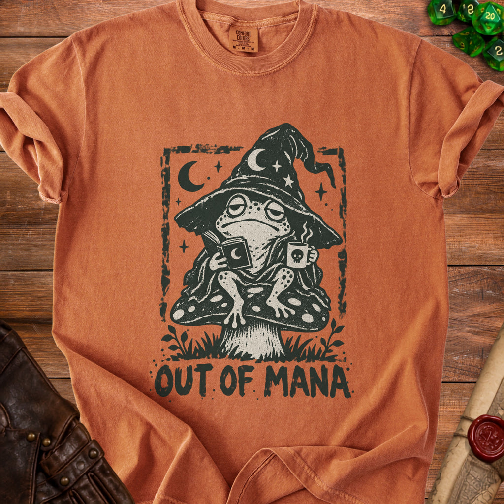 Orange t-shirt with a distressed graphic of a frog in a wizard hat reading and drinking, text "OUT OF MANA".