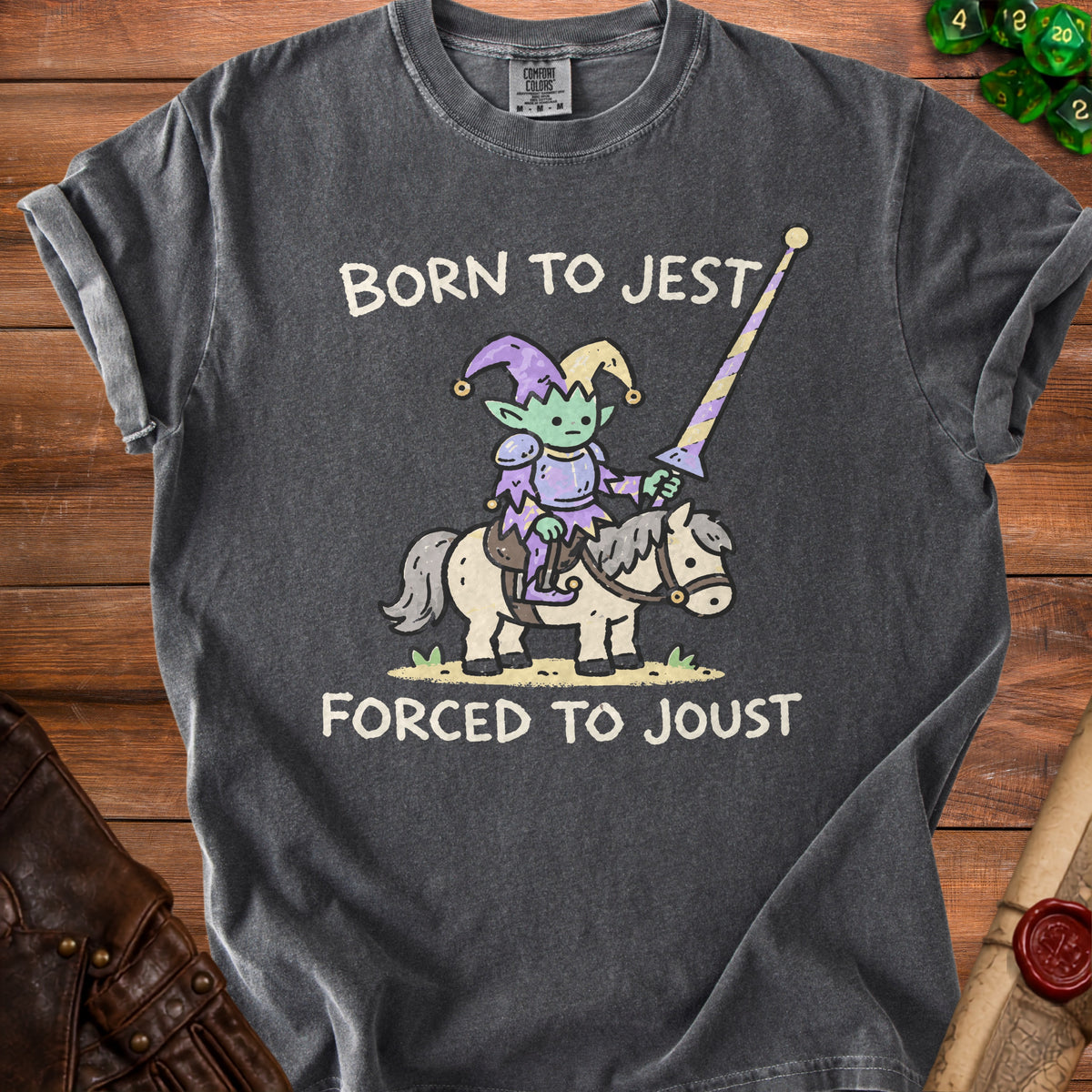 Dark grey t-shirt with "Born to Jest Forced to Joust" text and a cartoon elf jester on a horse.