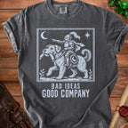 Dark gray t-shirt with a white graphic of a knight riding a dog, text reads "BAD IDEAS GOOD COMPANY".