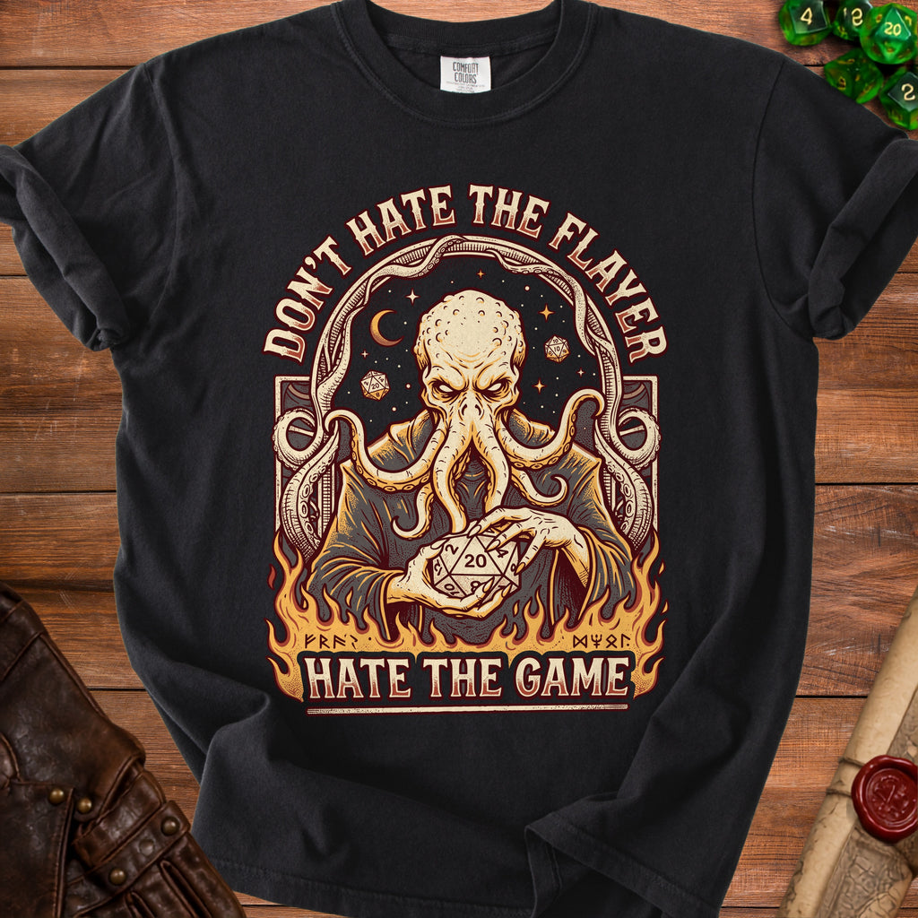 Black t-shirt with an octopus-like creature holding a twenty-sided die and text.