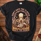 Black t-shirt with an octopus-like creature holding a twenty-sided die and text.