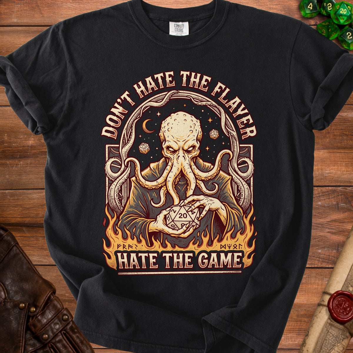 Black t-shirt with an octopus-like creature holding a twenty-sided die and text.