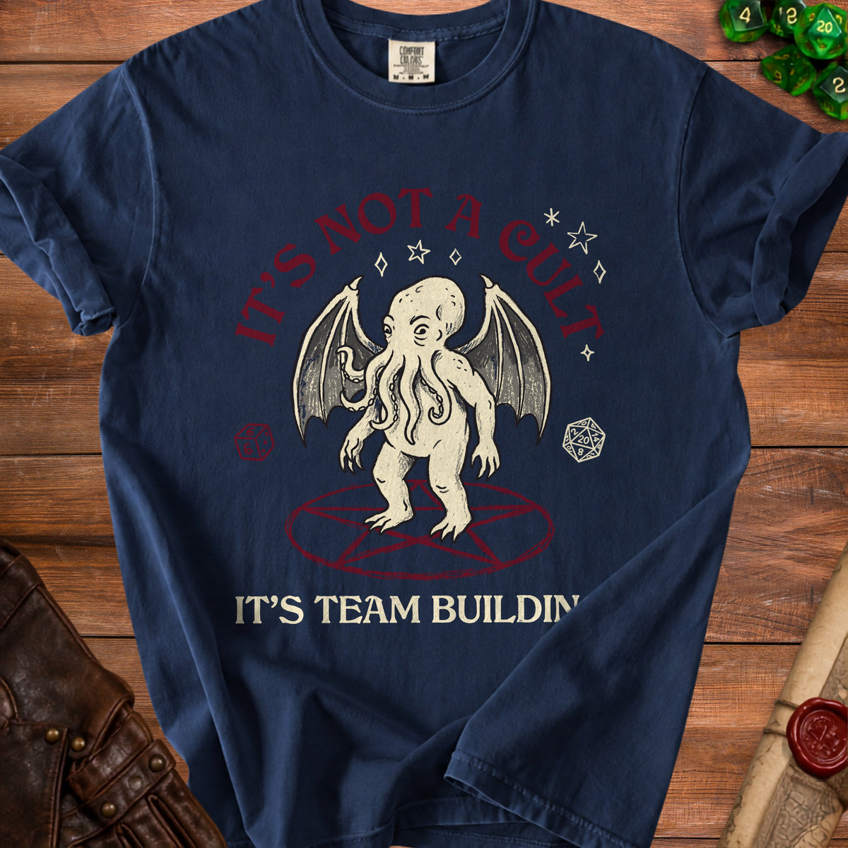 Navy blue t-shirt with Cthulhu graphic and text "IT'S NOT A CULT. IT'S TEAM BUILDING."
