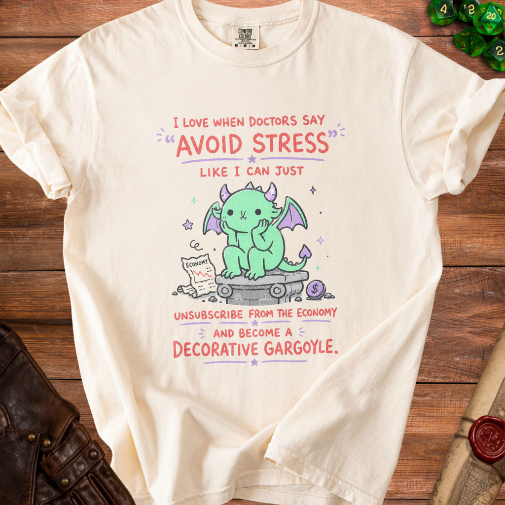 Cream t-shirt with graphic of a green dragon, an economy chart, and text about avoiding stress.