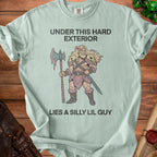 Light blue t-shirt with barbarian graphic and text "Under This Hard Exterior Lies A Silly Lil Guy".