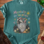 T-shirt graphic of raccoon in trash bin saying "Mentally on Vacation" and "Out of Office Forever".