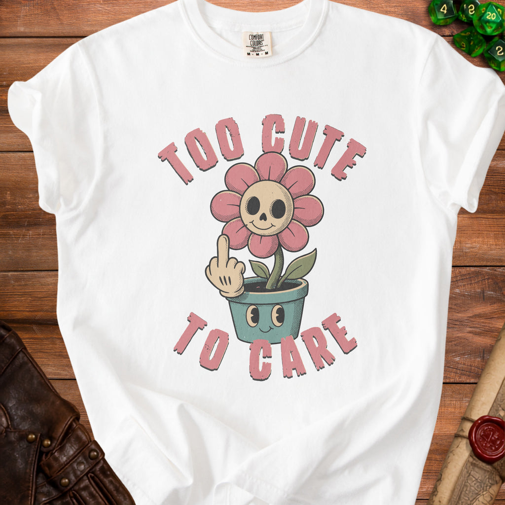 White t-shirt with skull flower graphic and text "TOO CUTE TO CARE".